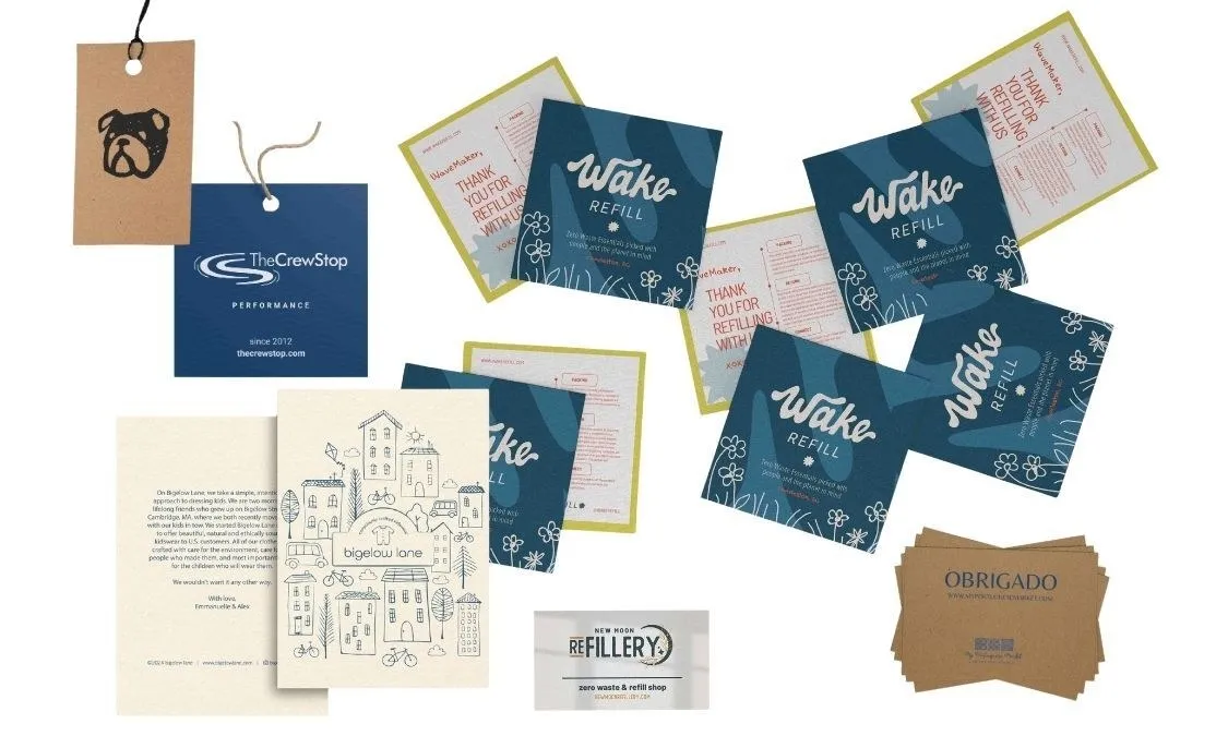 A spread of printed note cards, thank-you cards and hang tags in navy and kraft